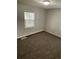 Cozy bedroom featuring neutral walls, plush carpeting, and a window for natural light at 2625 W Ellsworth Ave, Denver, CO 80219