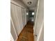 Hallway with wood floors, featuring closet and doorway into adjoining room at 2625 W Ellsworth Ave, Denver, CO 80219
