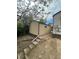 View of the shed showing siding, a small window and three concrete steps leading from the yard at 2625 W Ellsworth Ave, Denver, CO 80219