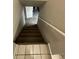 Staircase with carpeted steps, white walls, and a white handrail at 2625 W Ellsworth Ave, Denver, CO 80219