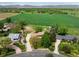 Aerial view of a home situated on a large lot with green fields and mountain views at 2117 Stonehenge Cir, Lafayette, CO 80026