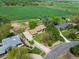 Aerial view of a property featuring a home with mature trees and spacious green fields at 2117 Stonehenge Cir, Lafayette, CO 80026