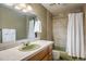 Retro bathroom featuring vintage fixtures, a mint green sink, and a tub-shower combination with classic tile at 2117 Stonehenge Cir, Lafayette, CO 80026