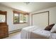 Bright bedroom featuring a neutral color palette, a large window, and a built-in wardrobe for ample storage at 2117 Stonehenge Cir, Lafayette, CO 80026