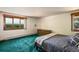 Bright bedroom with green carpet and expansive views of the yard and mountains at 2117 Stonehenge Cir, Lafayette, CO 80026