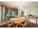 Dining room with a wooden table set, chandelier lighting, and a view into the inviting living space at 2117 Stonehenge Cir, Lafayette, CO 80026
