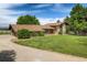 Beautiful home with a well-maintained lawn, mature trees, and a circular driveway at 2117 Stonehenge Cir, Lafayette, CO 80026
