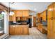 Traditional eat-in kitchen features wood cabinetry, tile flooring, and stainless steel refrigerator at 2117 Stonehenge Cir, Lafayette, CO 80026