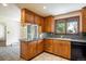 Cozy kitchen featuring wooden cabinetry, electric cooktop, sink with view to the lush yard at 2117 Stonehenge Cir, Lafayette, CO 80026