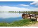 Scenic lake view with a Personal fishing on a wooden pier under a partly cloudy sky at 2117 Stonehenge Cir, Lafayette, CO 80026