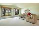 Bright living room with large windows showcasing outdoor views and comfortable seating arrangements at 2117 Stonehenge Cir, Lafayette, CO 80026