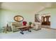 Inviting living room featuring neutral tones, plush seating, and a view into the entryway at 2117 Stonehenge Cir, Lafayette, CO 80026