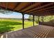 Covered patio providing an inviting outdoor space for relaxation with views of lush landscaping and open fields at 2117 Stonehenge Cir, Lafayette, CO 80026