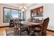 Traditional dining room with a large table, wood floors, built-in cabinet, and a bay window at 7205 Fallon Cir, Castle Rock, CO 80104