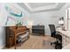 Home office featuring a piano, desk, and large artwork at 7205 Fallon Cir, Castle Rock, CO 80104