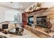 Cozy living room featuring a stone fireplace, built-in shelving, and access to an upper-level landing at 7205 Fallon Cir, Castle Rock, CO 80104