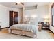 Inviting main bedroom with neutral tones, a ceiling fan, and an ensuite bathroom at 7205 Fallon Cir, Castle Rock, CO 80104