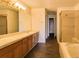 Bathroom features a double sink vanity, soaking tub with shower, and tile flooring at 6407 S Dallas Ct, Englewood, CO 80111