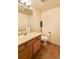 Clean bathroom features a vanity with a sink, toilet, and wood-look flooring at 6407 S Dallas Ct, Englewood, CO 80111