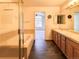 Bathroom featuring a double sink vanity, soaking tub, and a separate glass-enclosed shower at 6407 S Dallas Ct, Englewood, CO 80111