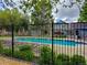 Community pool with seating, mature trees and a black metal fence at 6407 S Dallas Ct, Englewood, CO 80111