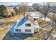Aerial view of a two-story home with detached garage and large backyard, snow on ground at 5300 Balsam St, Arvada, CO 80002