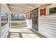 Charming front porch with metal door and white railing, perfect for relaxing outdoors at 5300 Balsam St, Arvada, CO 80002