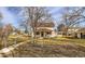 Two-story home featuring a covered front porch and red shutters, set on a spacious lot at 5300 Balsam St, Arvada, CO 80002