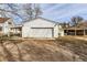 Detached garage with a large white door and ample parking space at 5300 Balsam St, Arvada, CO 80002