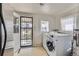 Laundry room featuring a washing machine and a security door at 5300 Balsam St, Arvada, CO 80002