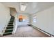 Cozy living room with stairs, shelving and a large window with orange shades at 5300 Balsam St, Arvada, CO 80002