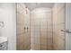 Spacious tiled shower featuring tiled walls, grab bar, and great lighting at 1801 Buttercup Rd, Elizabeth, CO 80107