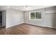 Bedroom with hardwood-style floors, a large window, and neutral walls at 1801 Buttercup Rd, Elizabeth, CO 80107