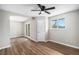Large bedroom featuring a ceiling fan, hard surface floors, and a large window at 1801 Buttercup Rd, Elizabeth, CO 80107
