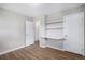 Bedroom with wood-look floors, a built-in desk, and ample closet space at 1801 Buttercup Rd, Elizabeth, CO 80107