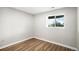 Bedroom featuring a large window, hard surface floors, and fresh paint at 1801 Buttercup Rd, Elizabeth, CO 80107