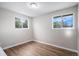 Bright bedroom with two windows, hard surface flooring, and fresh paint at 1801 Buttercup Rd, Elizabeth, CO 80107