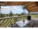 Covered deck with wood ceiling, table and chairs and picturesque view at 1801 Buttercup Rd, Elizabeth, CO 80107