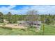 Charming single-story home with a covered porch and a sprawling lawn surrounded by mature trees at 1801 Buttercup Rd, Elizabeth, CO 80107