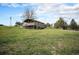 Two-story home on a large lot with a covered deck and mature trees at 1801 Buttercup Rd, Elizabeth, CO 80107