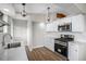 Stylish kitchen featuring white cabinets, stainless steel appliances, and pendant lighting at 1801 Buttercup Rd, Elizabeth, CO 80107