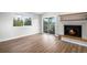 Cozy living room features wood floors, a fireplace and a large window that provides great natural light at 1801 Buttercup Rd, Elizabeth, CO 80107
