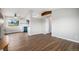 Open floor plan living room featuring wood floors, neutral walls, and an open concept to kitchen at 1801 Buttercup Rd, Elizabeth, CO 80107