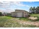 Outbuilding featuring a garage door and adjacent open grassy area at 1801 Buttercup Rd, Elizabeth, CO 80107