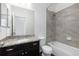 Bathroom featuring vanity with granite countertops and tiled shower and tub at 6284 N Genoa Way, Aurora, CO 80019