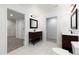 A bathroom featuring double vanity with a toilet, and tile floors at 6284 N Genoa Way, Aurora, CO 80019