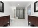 A bright bathroom featuring double vanity and walk-in shower at 6284 N Genoa Way, Aurora, CO 80019