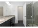 Bathroom showcasing double vanity, granite countertop, and a glass-enclosed shower at 6284 N Genoa Way, Aurora, CO 80019