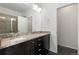 Bathroom showcasing double vanity, granite countertop, and tiled floor at 6284 N Genoa Way, Aurora, CO 80019