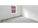 Neutral bedroom featuring carpet and a window providing natural light at 6284 N Genoa Way, Aurora, CO 80019